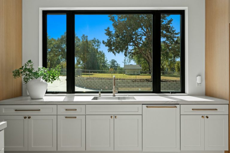 A large aluminum-framed sliding window in a modern residential setting