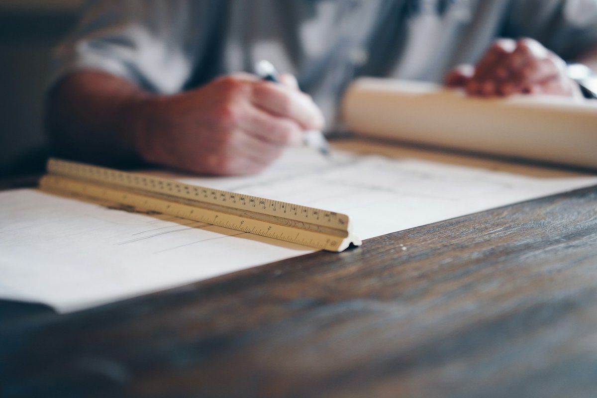Person drafting on blueprint