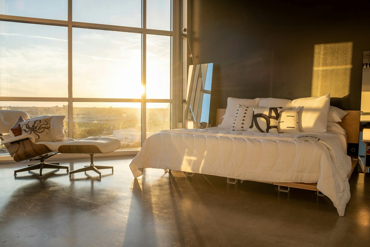 White bed near glass window
