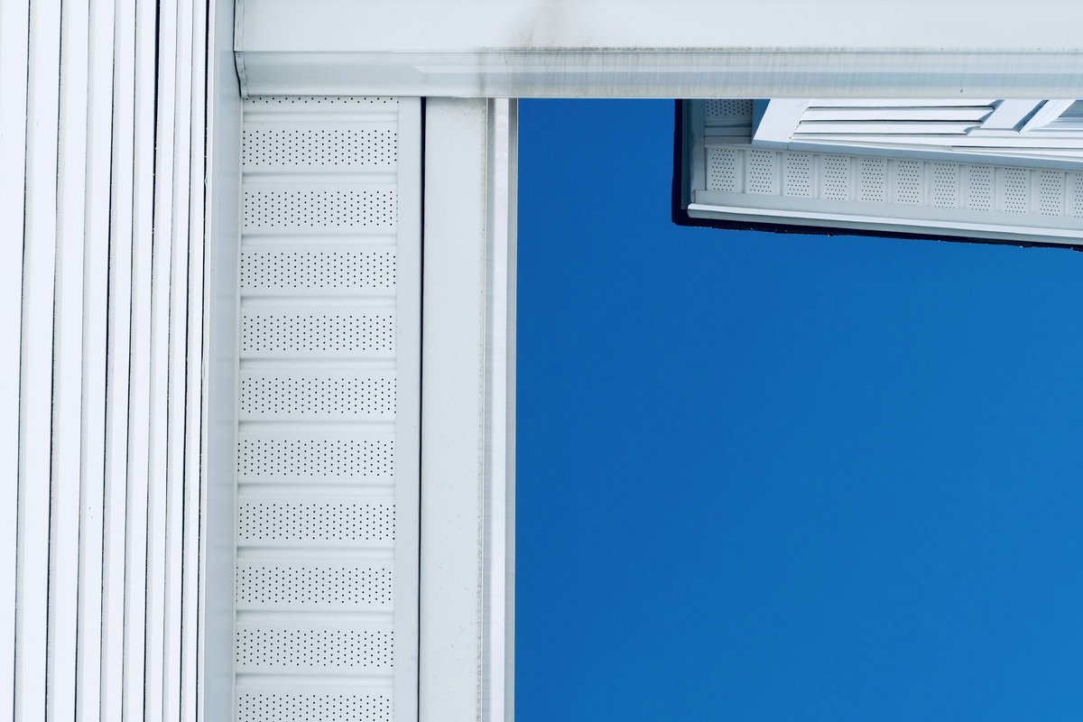 White siding against a bright blue sky