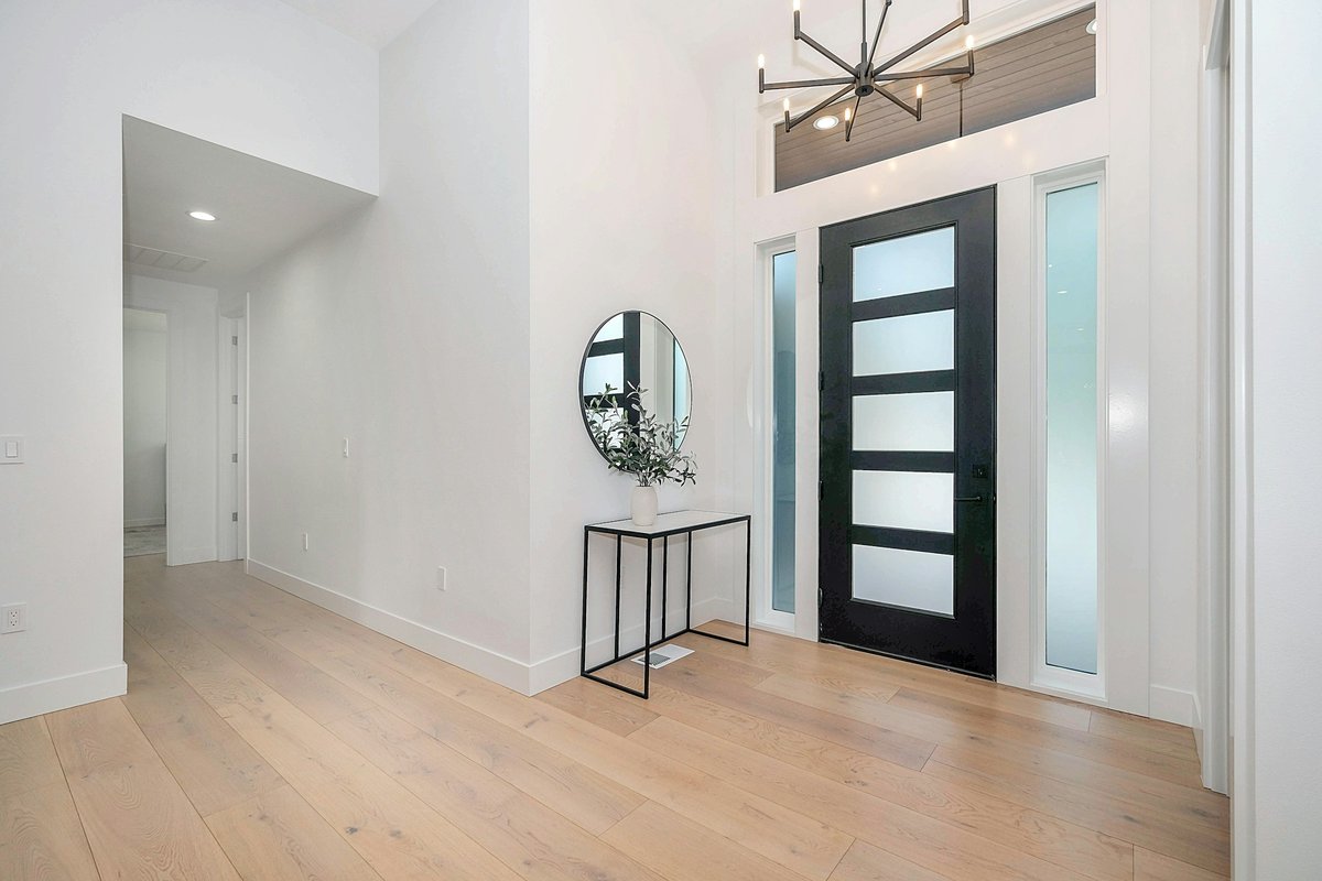 Black round wall mirror on white wall