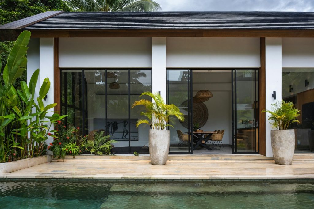 A house with a pool in front of it