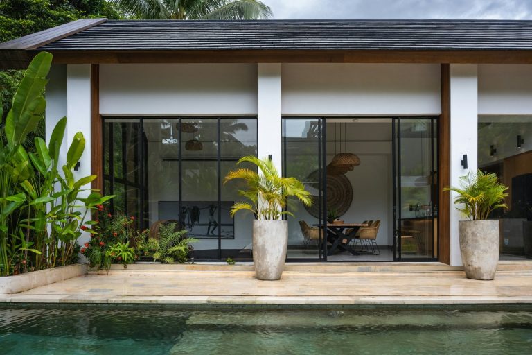 A house with a pool in front of it