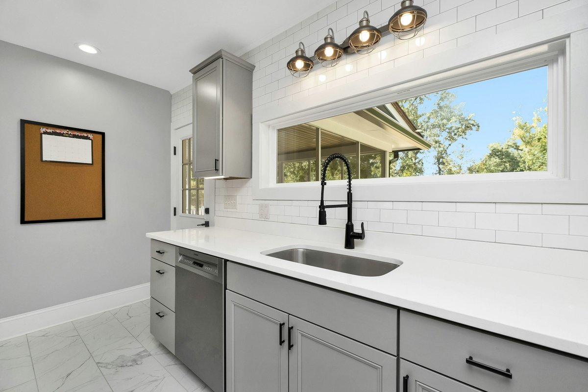 A kitchen with white cabinets