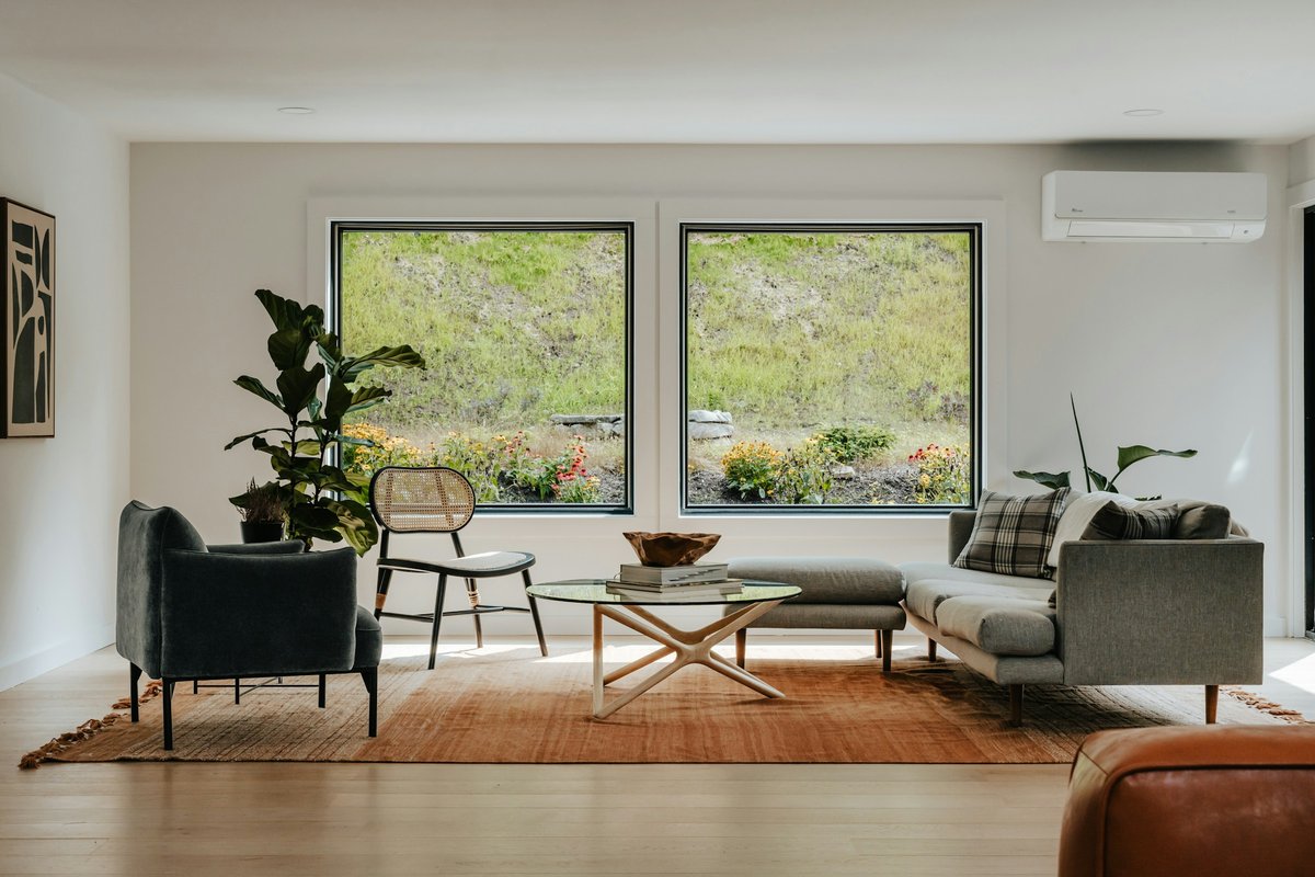 A living room filled with furniture and large windows