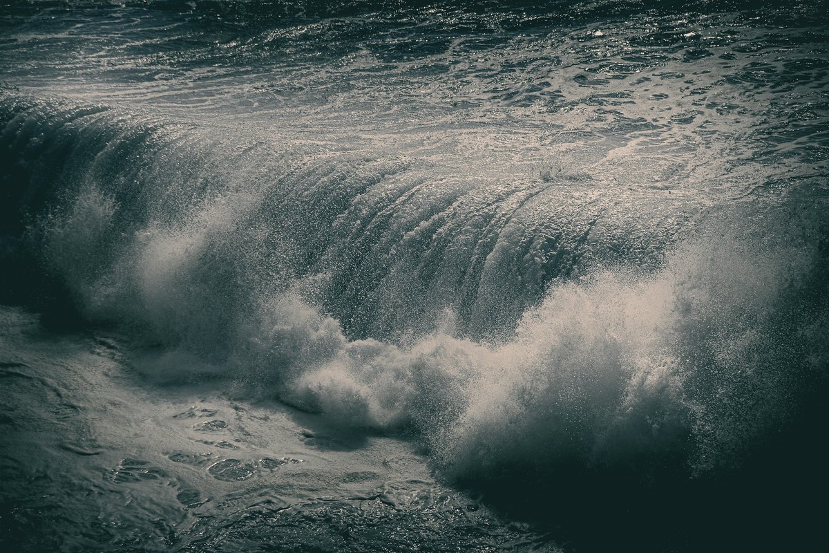 A man riding a wave on top of a body of water