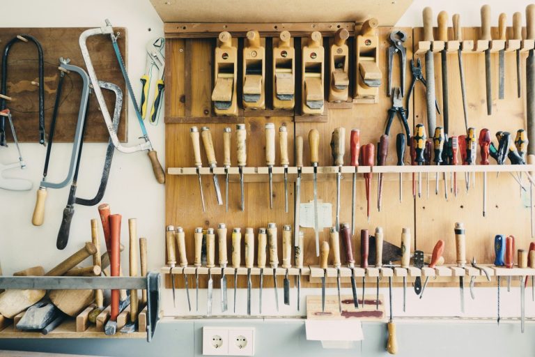 Assorted handheld tools in tool rack