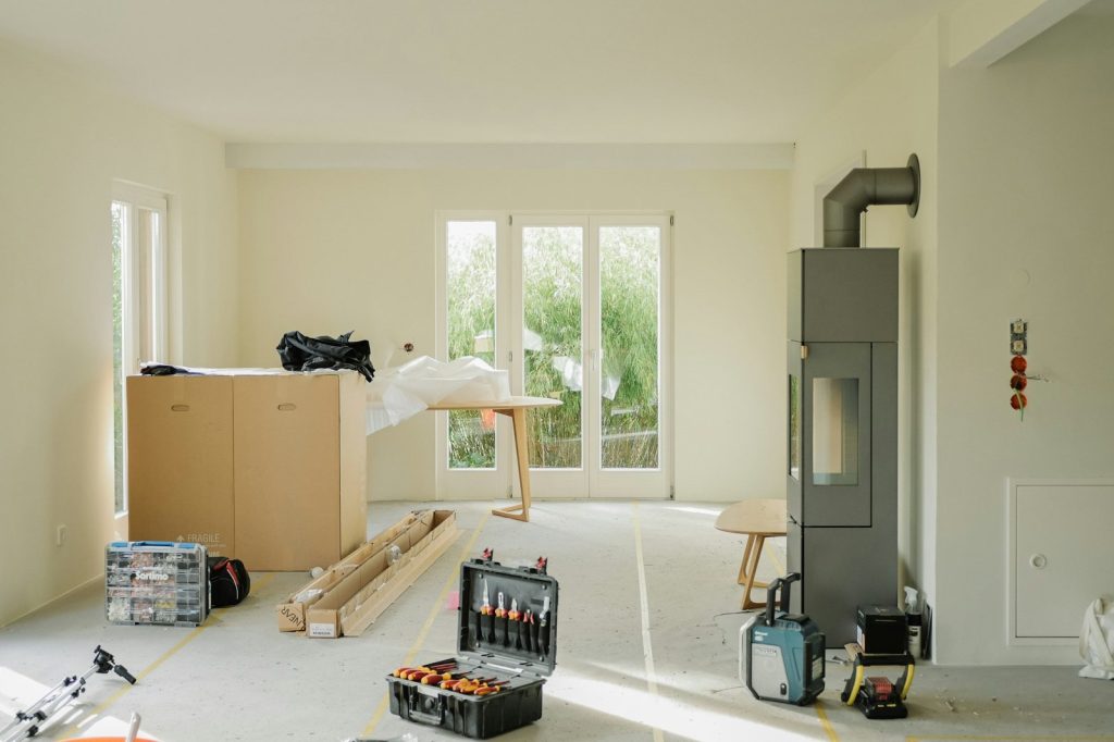 Room under renovation with tools and furniture.