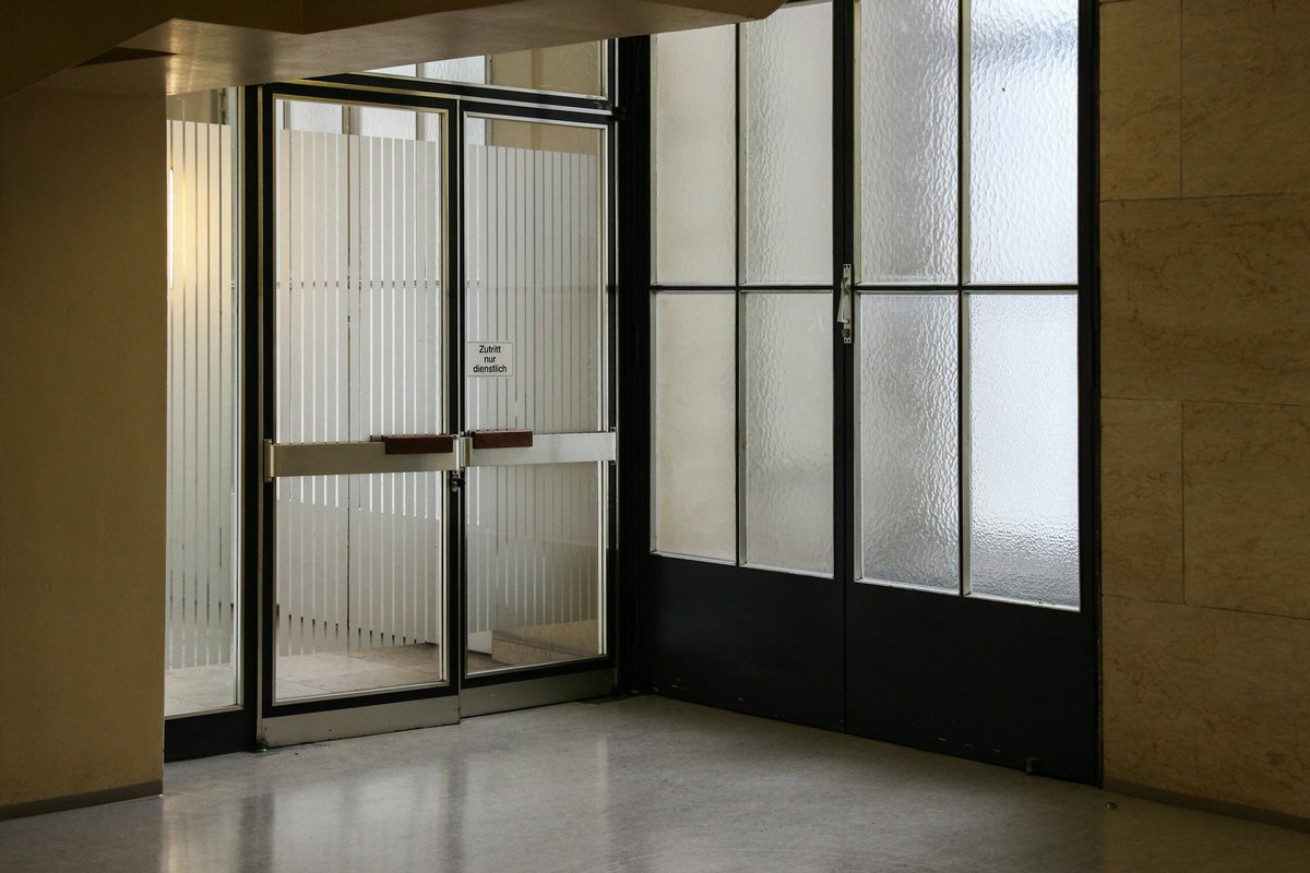 Closed gray stainless steel framed glass door