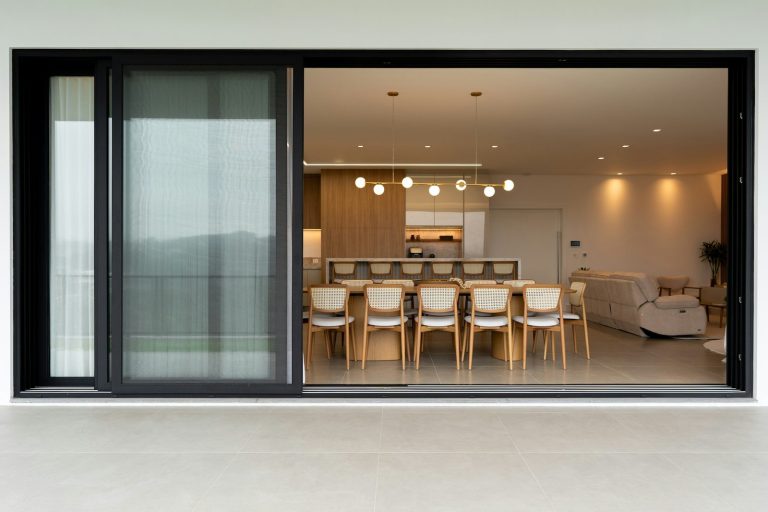 Modern dining room with chairs around a table.