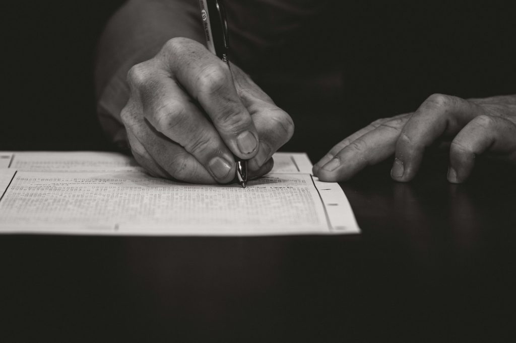 Hand writing with a fountain pen on paper.