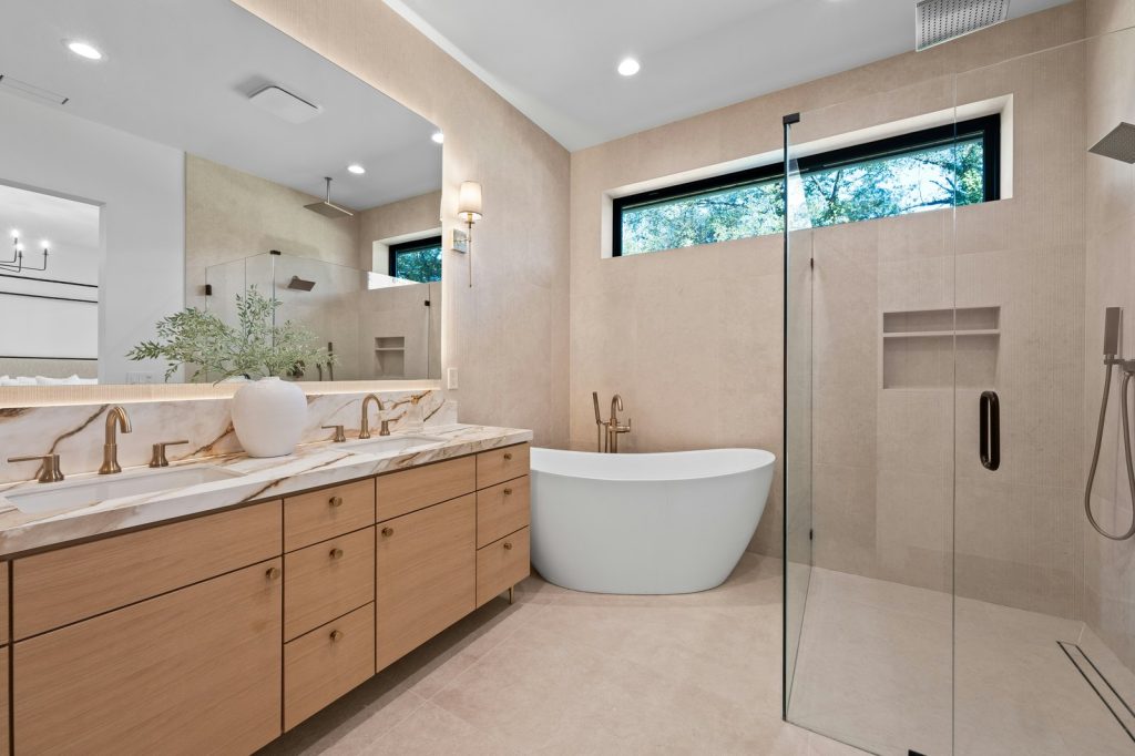 Modern bathroom with freestanding tub and double vanity.