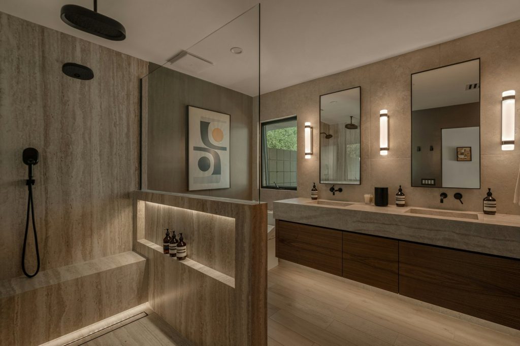 Modern bathroom with double vanity and walk-in shower.