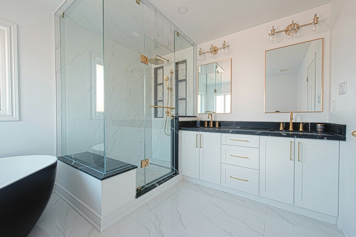 Spa-style bathroom showing the kind of frameless shower partition that suits a wellness retail space