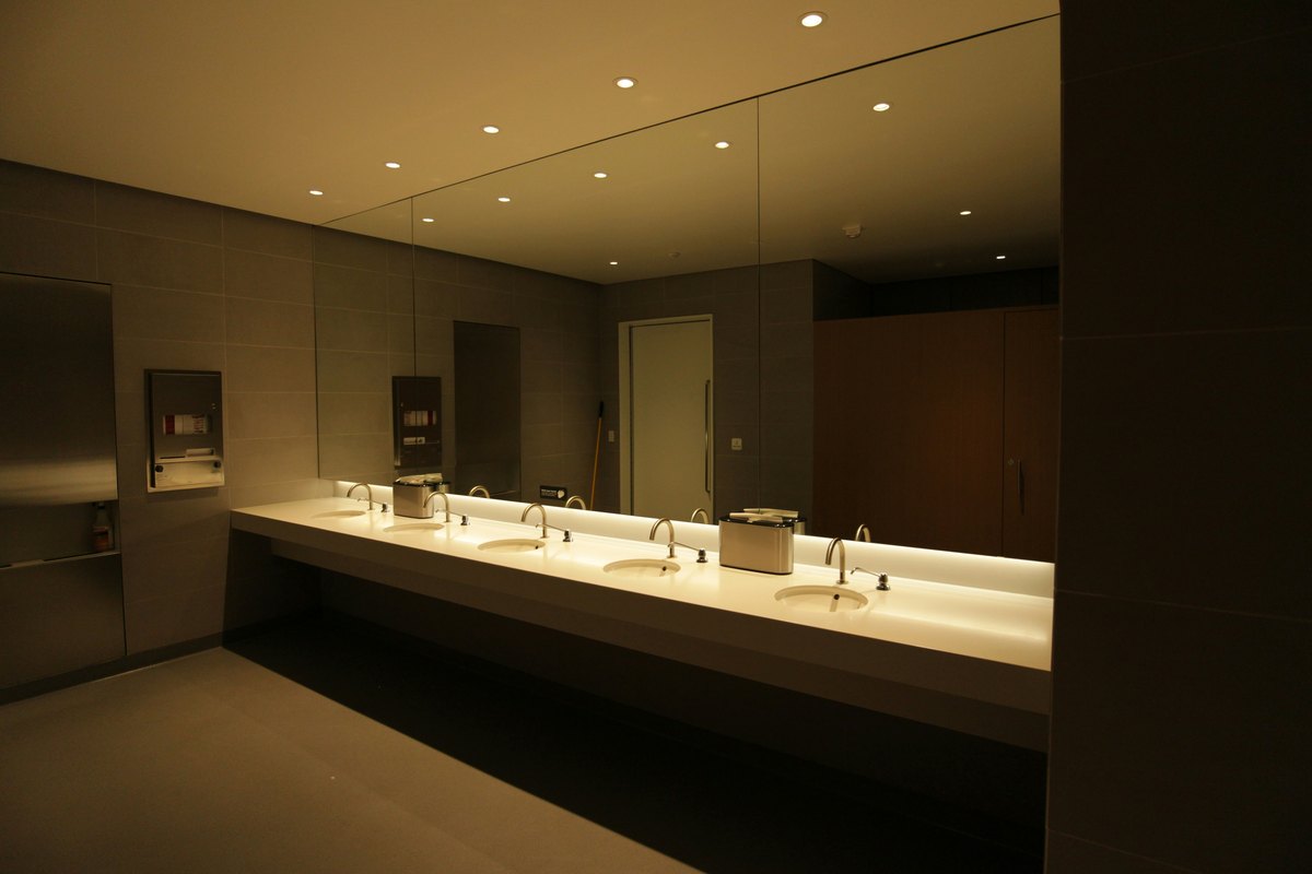 Modern public commercial restroom showing the scale and finish typical of a code-compliant fit-out