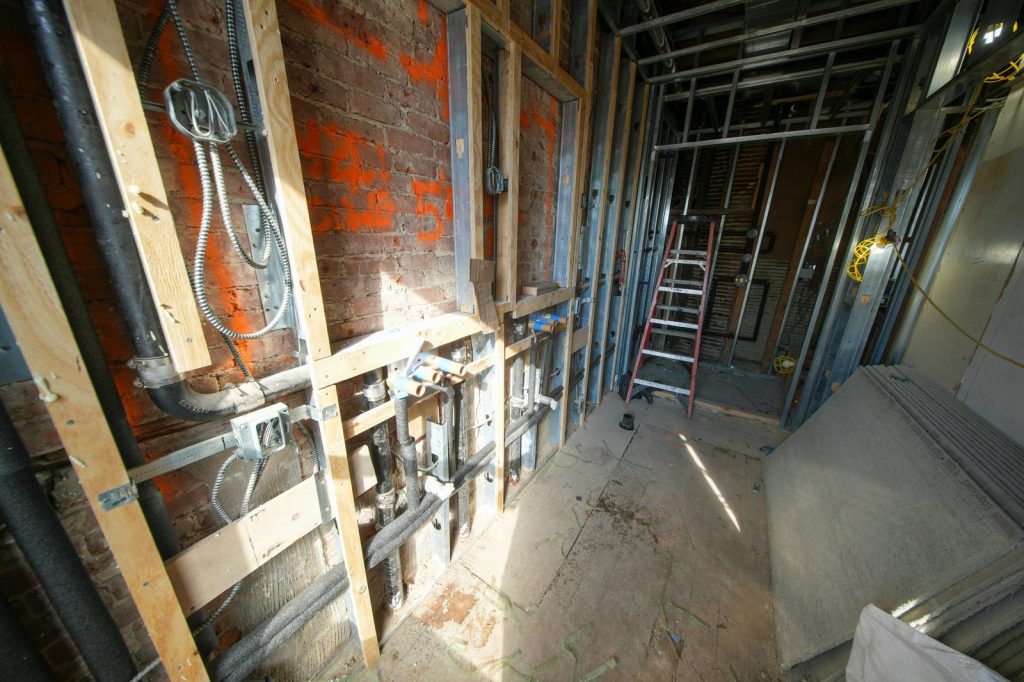 Interior construction with exposed pipes and framing