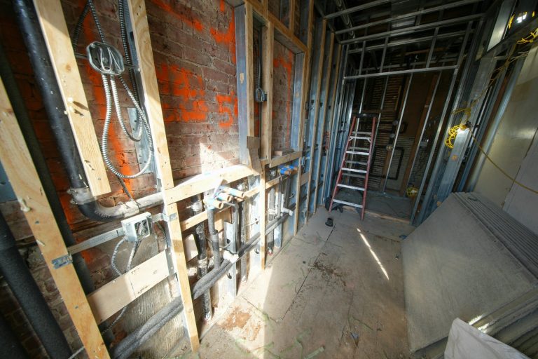 Interior construction with exposed pipes and framing