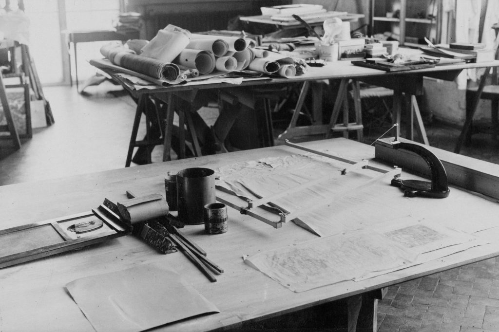 Architectural drafting table with blueprints and tools