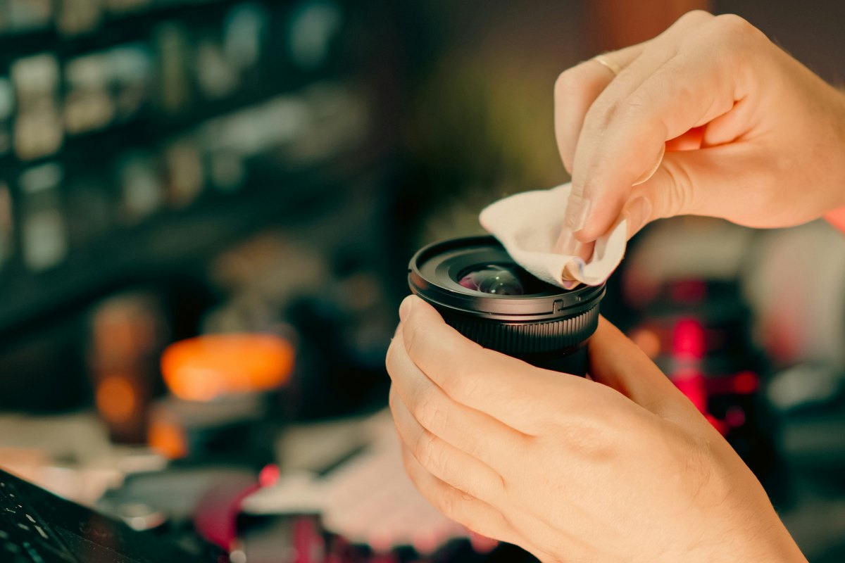 Hands cleaning glass with a microfiber cloth showing the kind of gentle, controlled cleaning that protects the finish