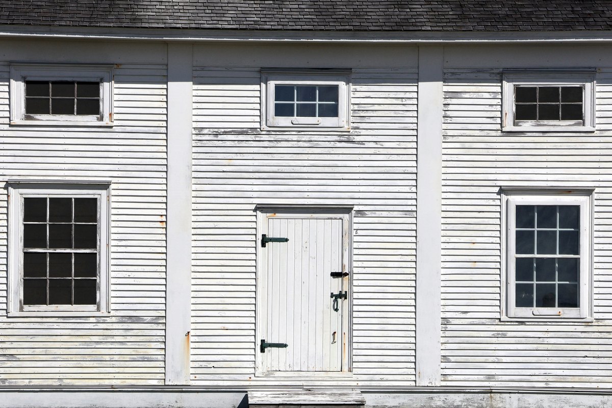 A weathered coastal home showing the kind of salt-air aging that affects every exposed component
