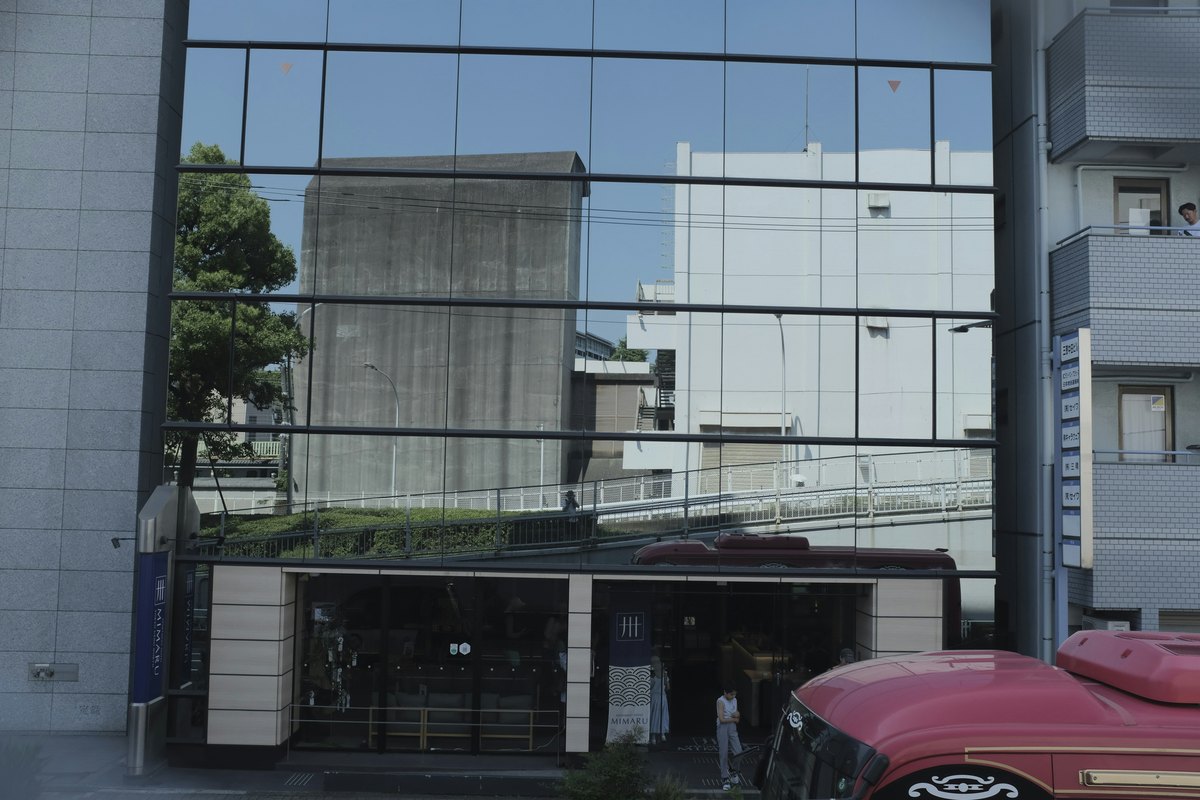 Modern building with a glass facade showing the kind of large-panel storefront that needs careful thickness specification