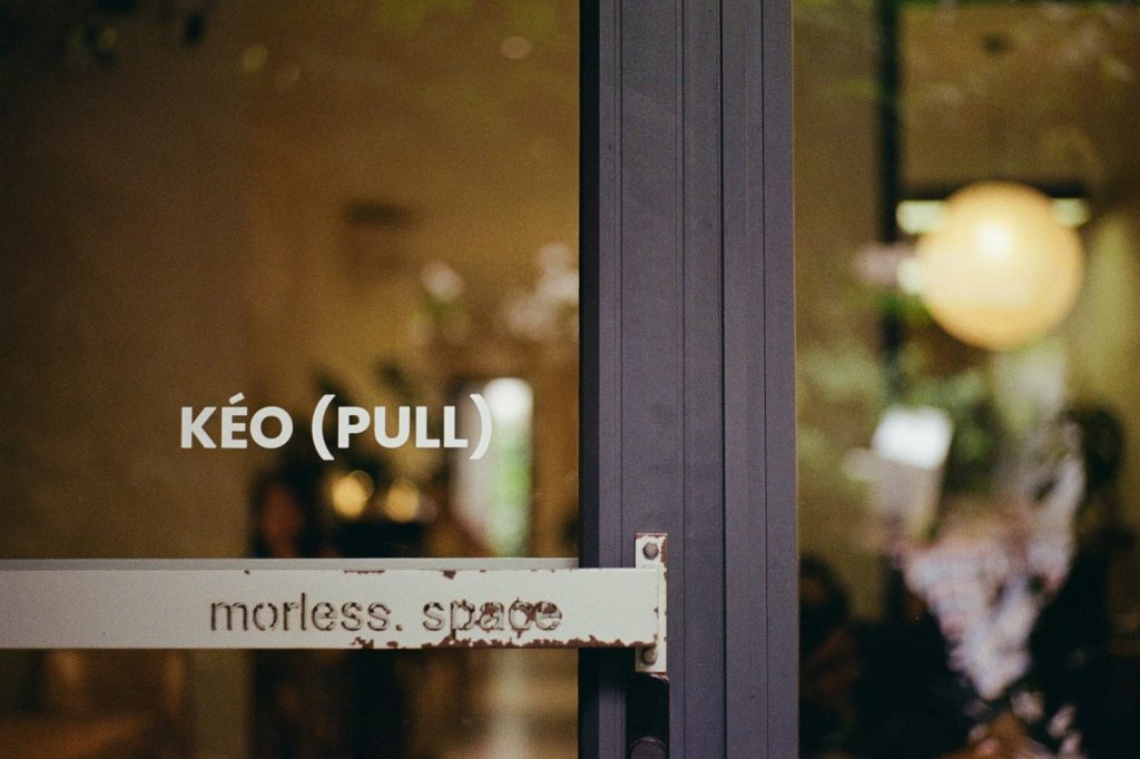 Glass door with pull handle and text labels