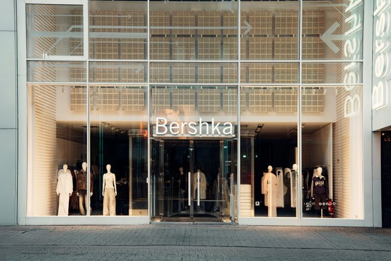 A store front with a large glass window and mannequins