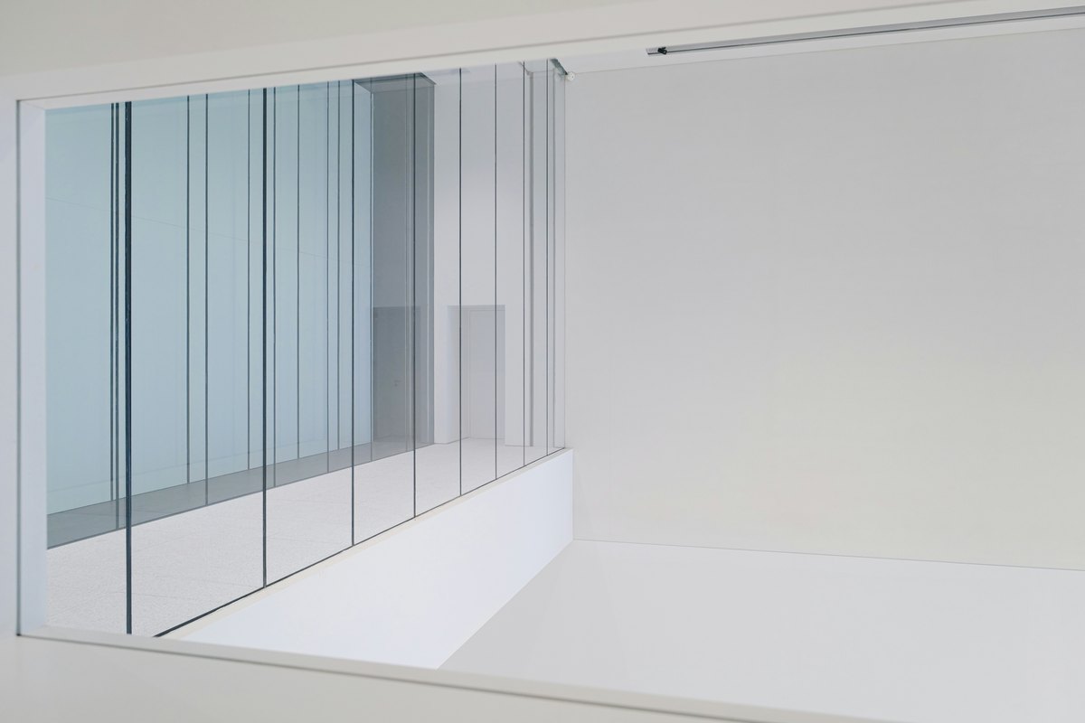 Clean white interior with a sleek glass door, showing the kind of design integration custom installs allow