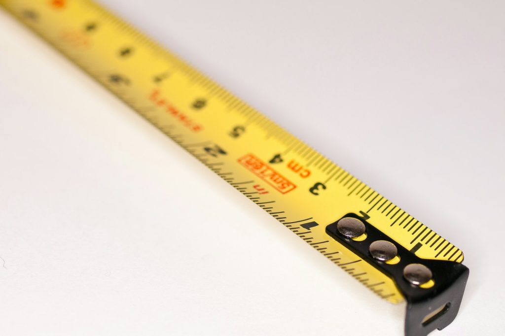 a yellow measuring tape with a black handle