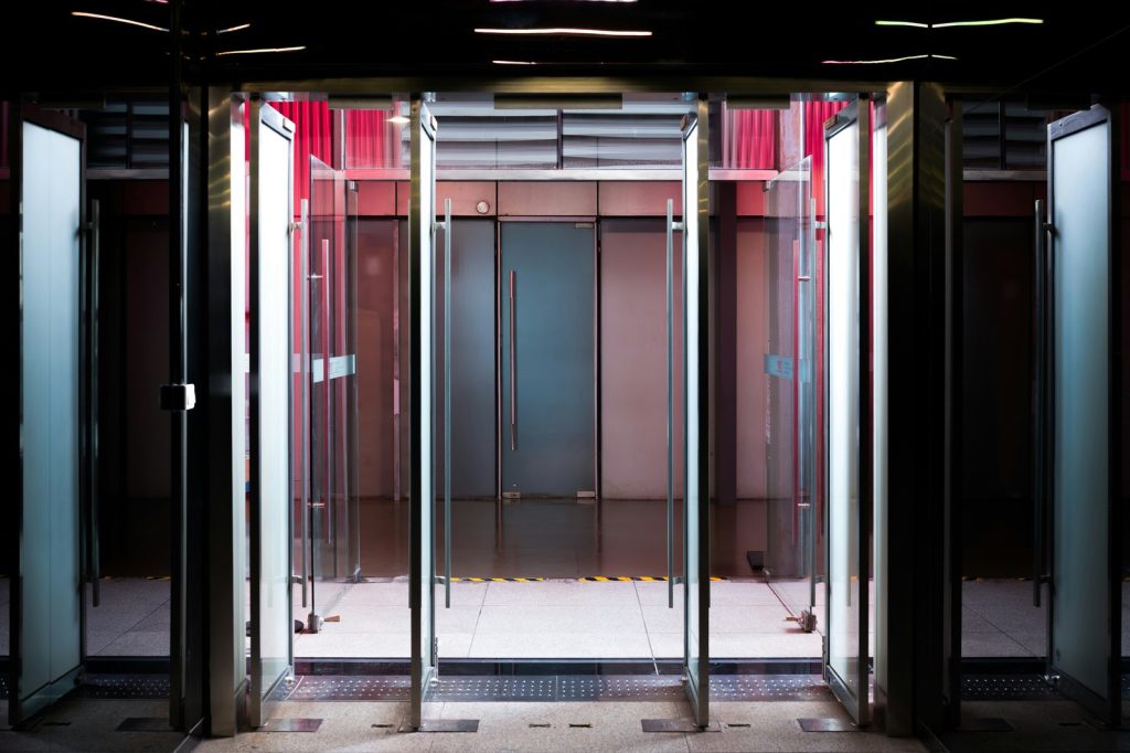 Glass revolving doors with modern interior lighting