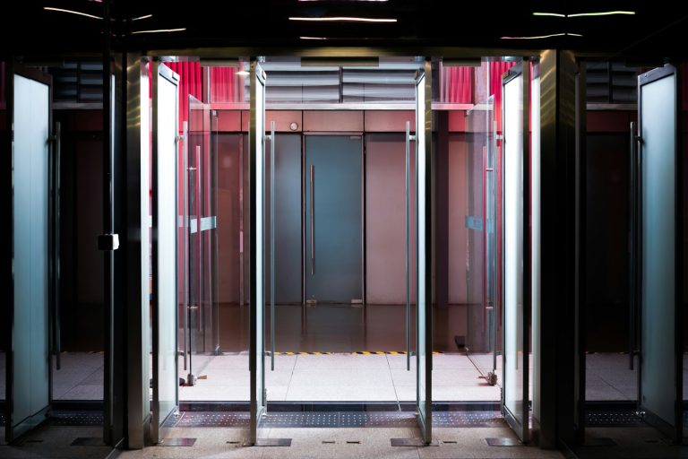 Glass revolving doors with modern interior lighting