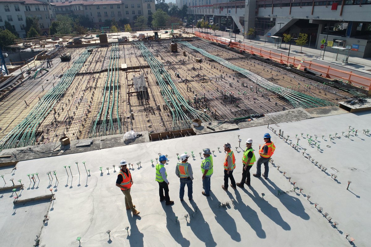 Construction workers reviewing plans, showing the kind of coordination that bulk storefront work requires