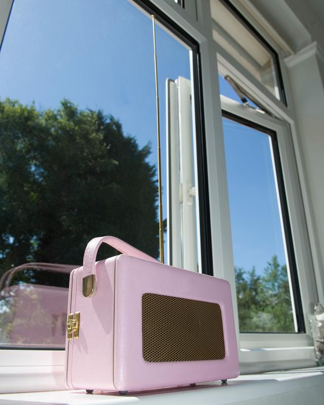 Retro radio in a sunny window with a view outside